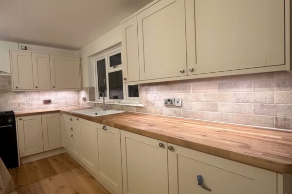 a cream kitchen with wood floor and worktops