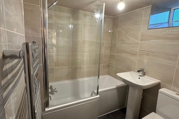 a compact bathroom with sink and toilet