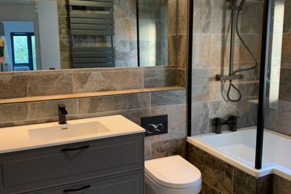 a bathroom with sink, toilet and shower